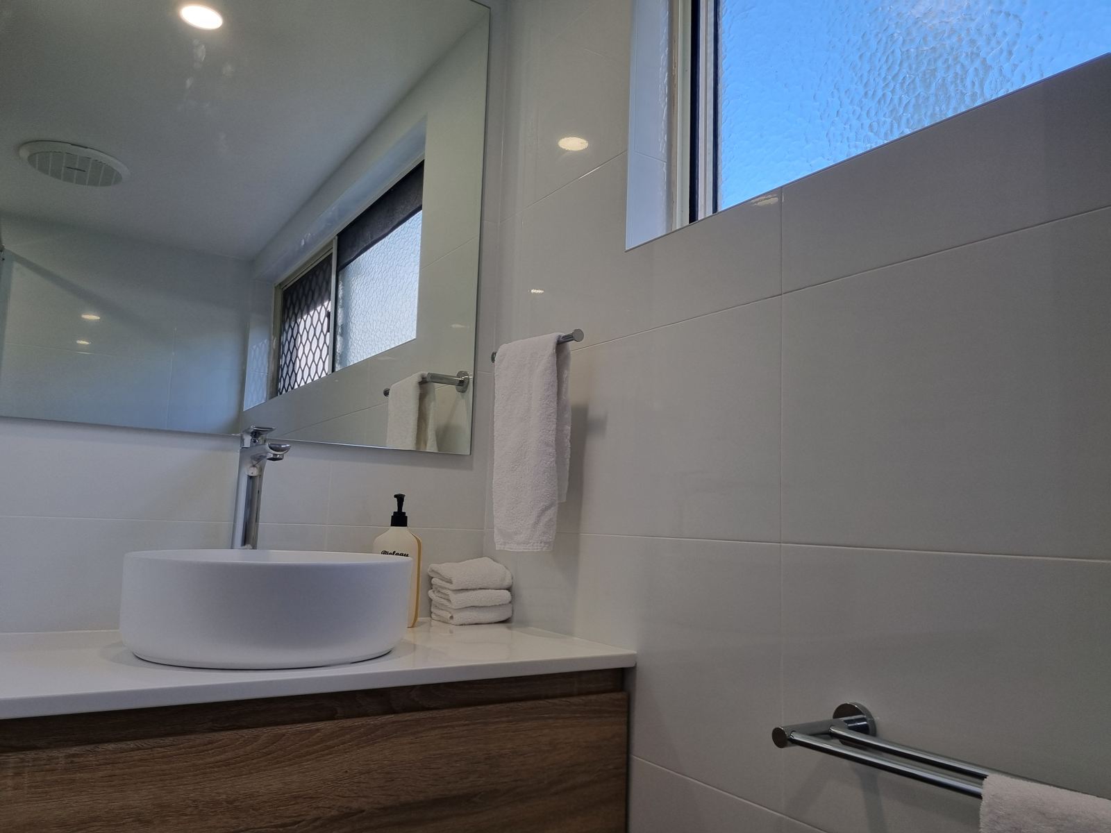 Bathroom vanity with round basin and fresh hand towels